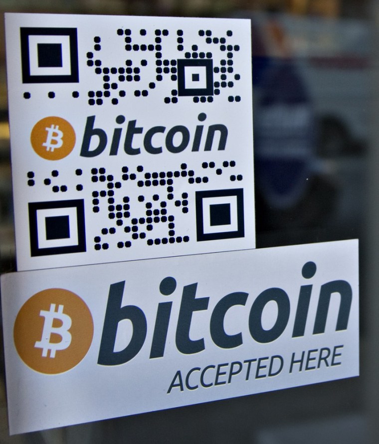 Signs on window advertise a bitcoin ATM machine that has been installed in a Waves Coffee House in Vancouver, British Columbia October 28, 2013. The n...