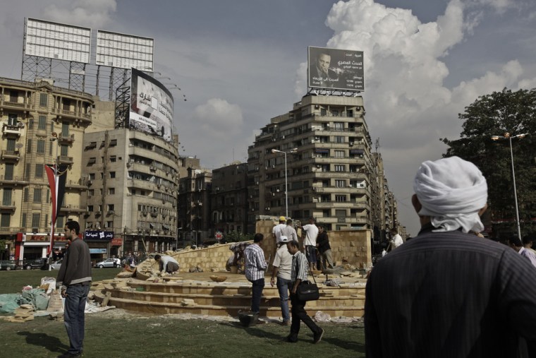 Municipality laborers working on a memorial base two days before the commemoration of the deadly 2011 clashes in Tahrir Square, Cairo, Sunday.