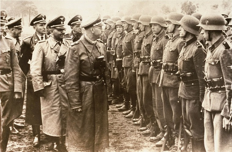 Heinrich Himmler, center, head of the Gestapo and the Waffen-SS, and Minister of the Interior of Nazi Germany from 1943 to 1945, reviews troops of the Galician SS-Volunteer Infantry Division. Michael Karkoc a top commander whose Nazi SS-led unit is blamed for burning villages filled with women and children lied to American immigration officials to get into the United States and has been living in Minnesota since shortly after World War II, according to evidence uncovered by The Associated Press.