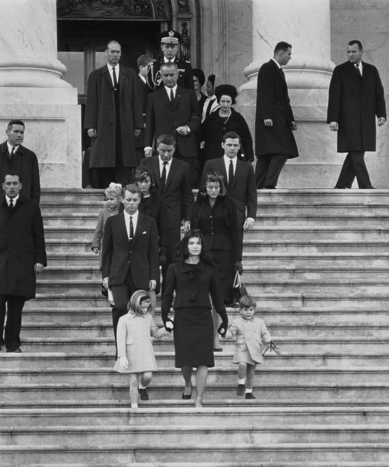 Kennedy family members descend steps in Washington, Nov. 25, 1963, at the funeral for President John F. Kennedy. From front to back at left are: Caroline Kennedy, Jacqueline Kennedy and John Kennedy Jr.; behind them, Robert F. Kennedy, Patricia Kennedy Lawford and her husband, Peter Lawford; Little Sydney Lawford is at left of her mother. Behind Mrs. Kennedy are Jean Kennedy Smith and her husband Stephen E. Smith. Near top are President Lyndon B. Johnson and his wife Lady Bird Johnson. Behind the vice president is the chairman of the Joint Chiefs of Staff, Maxwell D. Taylor.