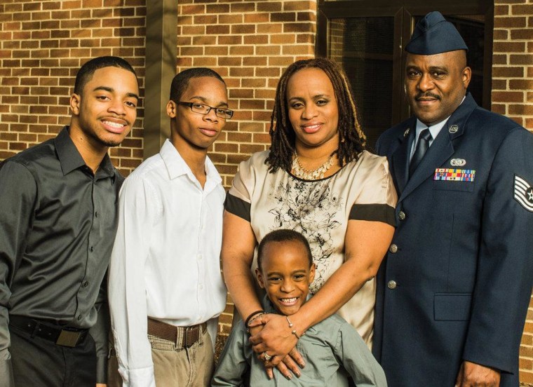 \"As military families, we're trained not to panic.\" Left to right, sons Caleb, Aaron and Ethan, mom Alicia Hinds Ward, and her husband, Edwinston Ward, an Air National Guard sergeant.