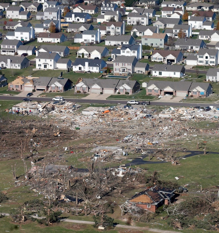 Untouched homes stand on Nov. 18, 2013 near where others were completely destroyed by a tornado that hit Washington, Illinois the previous day.