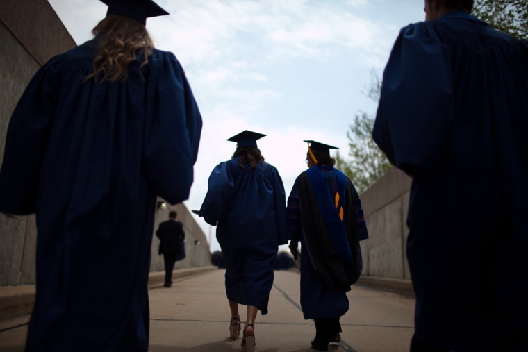 Alumni of the University of Illinois at Urbana-Champaign school of business emerge from a tunnel of the State Farm Center after participating in comme...