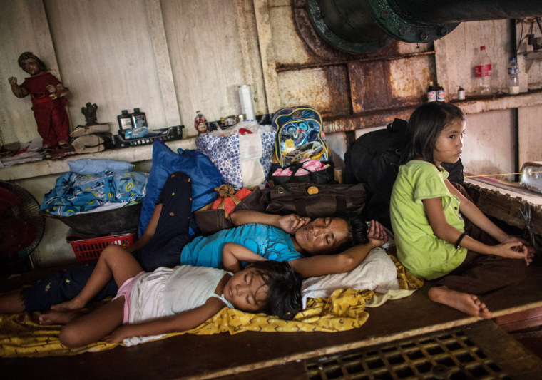 One of several families to have resorted to sleeping in the hull of a ship in a particularly badly damaged part of Tacloban.
