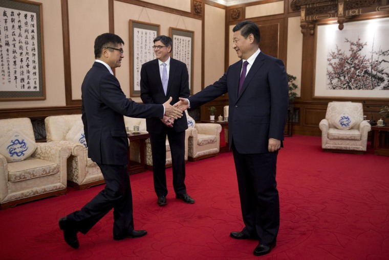 U.S. Ambassador to China Gary Locke, left, shakes hands with Chinese President Xi Jinping before a meeting with U.S. Treasury Secretary Jack Lew, center, last week.