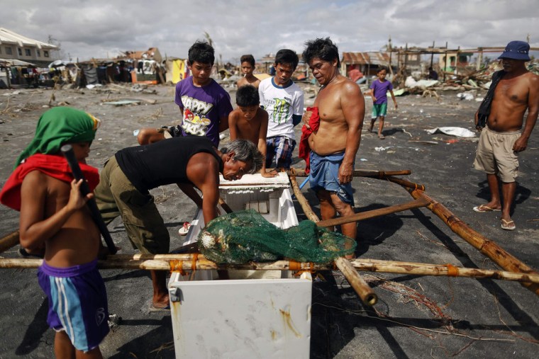 Jimmy Obaldo, second right, looks at his catch.