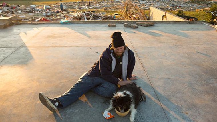 Dann said it was \"unreal'' that the family dog made it through the tornado, which Dann survived while huddled with his four children in the basement bathroom as it destroyed their home.