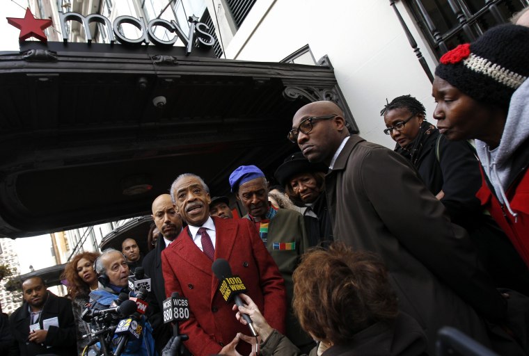 Rev. Al Sharpton, center, speaks to the media outside Macy's department store after meeting with company officials in New York in this Nov. 4, 2013, file photo. The New York City Council is asking 17 retailers about their policies as it looks into allegations of racial profiling.