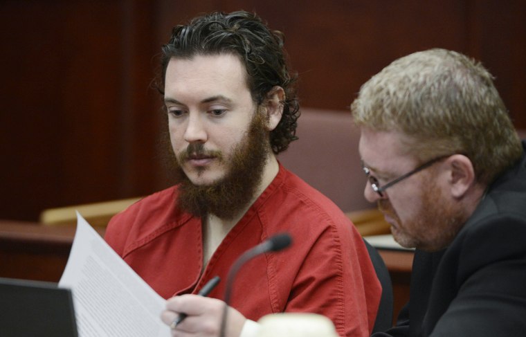 James Holmes and his defense attorney Daniel King (R) sit in court for an advisement hearing at the Arapahoe County Justice Center in Centennial, Colorado in this June 4, 2013 file photo. Police did not allow the accused theater gunman access to lawyers for 13 hours after he asked for legal counsel following his arrest, and ignored demands by his lawyers that he not be interrogated, defense attorneys said on October 18, 2013.