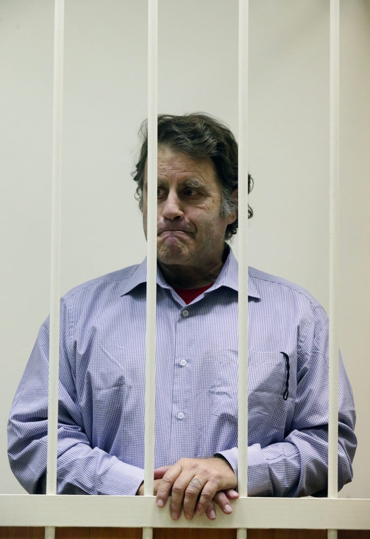 The American captain of the 'Arctic Sunrise' ship Peter Henry Wilcox stands in a detention cage during a hearing at the Kalininsky courthouse in St. Petersburg.