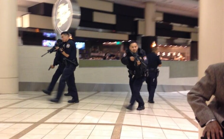 Officers with assault rifles move through a terminal at Los Angeles International Airport on Friday night after reports of gunfire. The reports turned out to be unfounded.