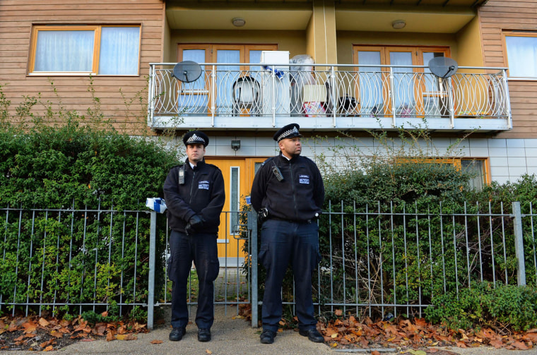 Police stand guard outside a block of residential apartments as house-to-house inquiries are carried out in South London on Nov. 23, 2013 concerning the recent discovery of three women held captive for 30 years.