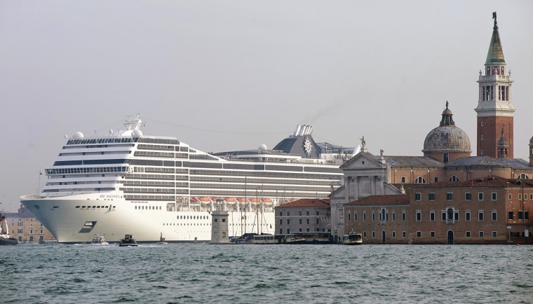 The MSC Magnifica cruise liner ship passes near St. Mark's Square in Venice's basin on January 23, 2011. A boom in floating vacations is presenting a dilemma for coastal communities around the world.