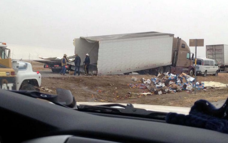 Debris is strewn along Interstate 40 after a multi-vehicle accident near Vega, Texas, that killed three on Saturday.
