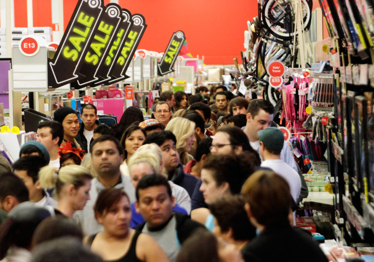 A crowd of shoppers browse at Target on the Thanksgiving Day holiday in Burbank, California in this November 22, 2012, file photo. Opening their doors...