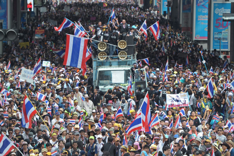 Anti-government protesters wave national flags during a demonstration in Bangkok, Monday.