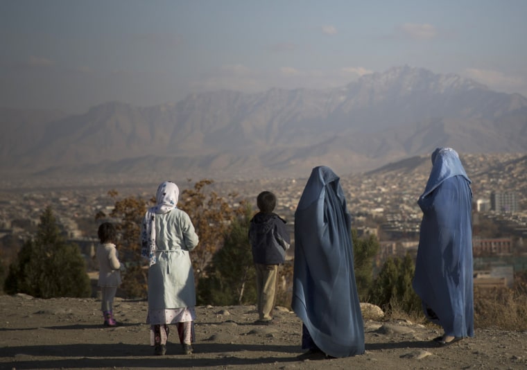 Afghan women with their children enjoy a view over Kabul, Afghanistan, Monday, Nov. 25, 2013. Human Rights Watch says that the Afghan government should reject a proposal to reintroduce public stoning as a punishment for adultery, but the Justice Ministry says such a law has not yet been sent for review as part of a new penal code that is still being drafted.