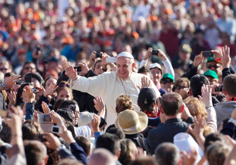 Pope Francis waves to faithful as he is driven through the crowd during his weekly General Audience in St. Peter's Square at the Vatican, Wednesday, Oct. 23, 2013.