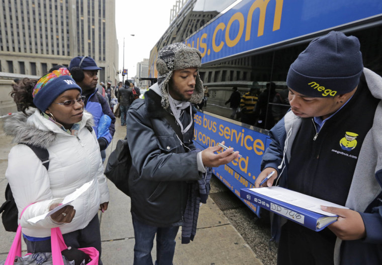 Chynnah Clasberry, left, and her cousin David Ruffin prepare to board a Megabus in Chicago on Tuesday for a trip to Atlanta.
