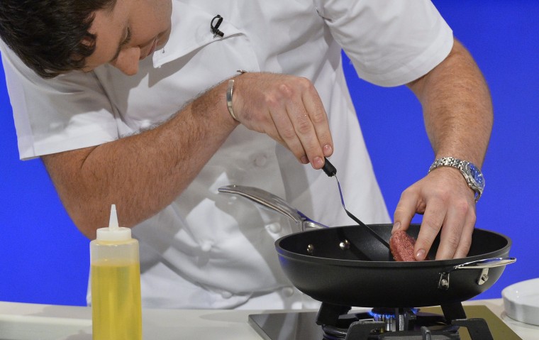 Chef Richard McGeown cooks the world's first lab-grown beef burger during a launch event in west London August 5, 2013. The in-vitro burger, cultured ...