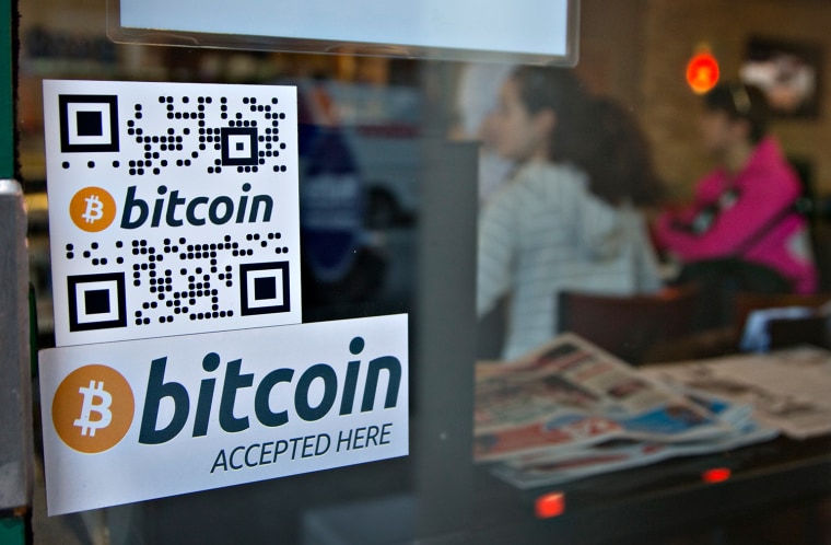 Signs on window advertise a bitcoin ATM machine that has been installed in a Waves Coffee House in Vancouver, British Columbia October 28, 2013. The n...