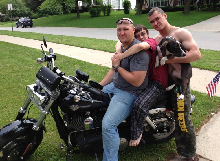 Staff Sgt. Howard Linville (left) with his younger brothers in Tipton, Iowa, in March.