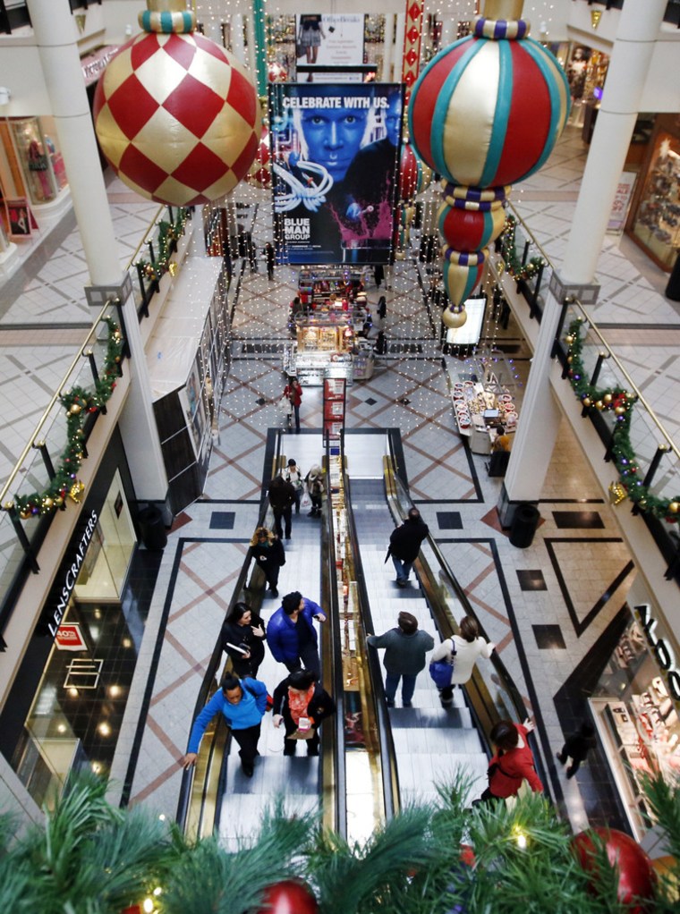 Shoppers ride escalators in a mall in Cambridge, Mass., Tuesday, Nov. 26, 2013. Shoppers in many states will line up for deals hours after their Thanksgiving dinners, but stores in a handful of states are barred by law from opening on the holiday.