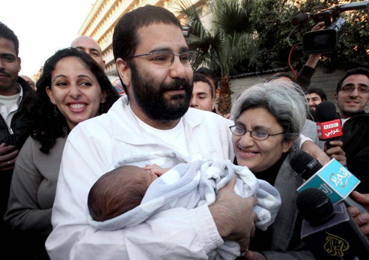Egyptian blogger Alaa Abdel-Fattah holds newborn son, Khaled, and stands with mother Laila Soueif, right, and sister Ahdaf Soueif, left, after his release from a Cairo prison in 2011.
