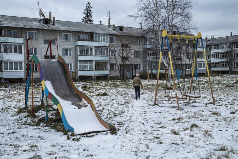 A woman walks through a playground outside a block of apartments in Baikalsk, Russia. The local economy has been devastated by the recent bankruptcy of the Siberian town's only major employer -- a pulp and paper mill which for decades polluted Lake Baikal.