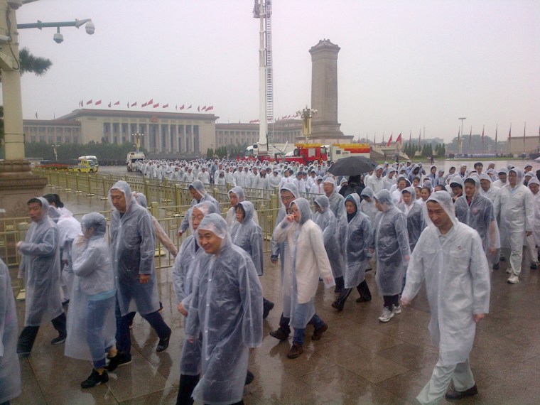 Pleased it's over, students leave Tiananmen Square after washed-out National Day celebrations in Beijing.
