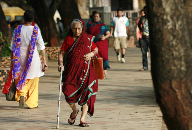 An elderly Indian woman walks at a park on International Day of Older Persons in Mumbai, India,Tuesday, Oct. 1, 2013. Much of the world is not prepare...