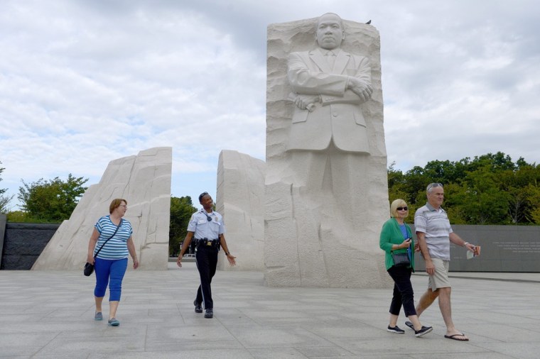 A U.S. Park Police officer asks tourists to leave the Martin Luther King Jr. Memorial as it is closes in Washington on Oct. 1.