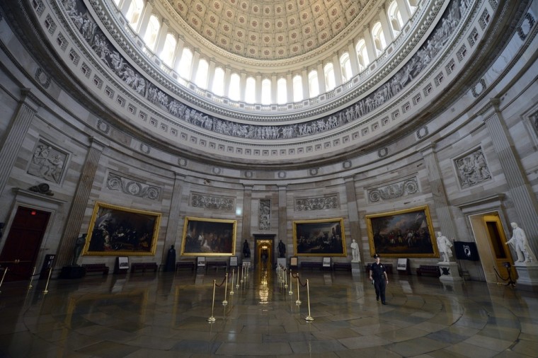 A Capitol police officer walks through the Capitol Rotunda, empty of visitors after being closed to tours, during the government shutdown on Capitol Hill in Washington DC, USA, 01 October 2013.