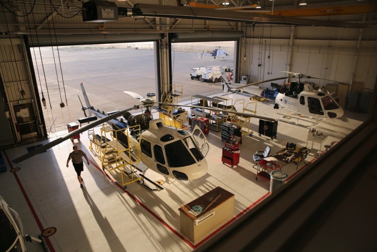 A maintenance worker prepares helicopters for duty.