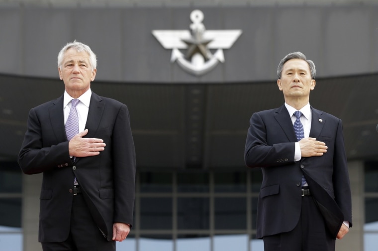 U.S. Secretary of Defense Chuck Hagel, left, salutes with his South Korean counterpart Kim Kwan-jin during the honor guard welcome ceremony at Defense Ministry in Seoul, South Korea, Wednesday, Oct. 2, 2013. Hagel and Kim will attend the 45th Security Consultative Meeting, or SCM. (AP Photo/Lee Jin-man)