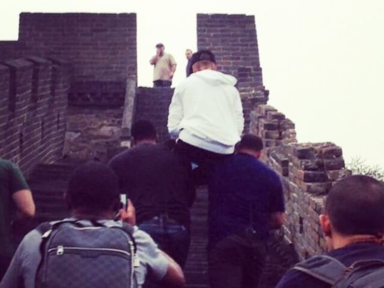 Justin Bieber gets a little help from his friends while on the Great Wall of China.