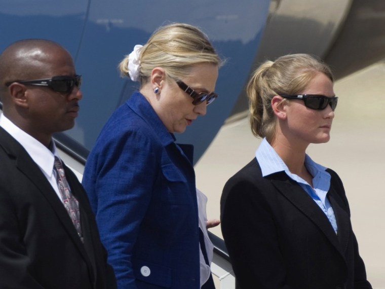 U.S. Secretary of State Hillary Clinton steps down between Secret Service officers upon arriving at Torrejon's air base, near Madrid, July 1, 2011. Cl...