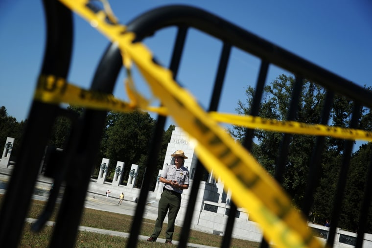 A park ranger of the U.S. National Park Service stands behind the barricades at the World War II Memorial during a government shutdown October 1, 2013 in Washington, DC.
