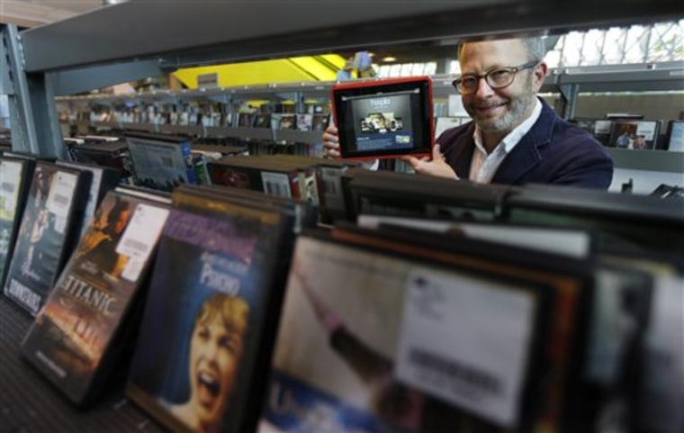 In this Sept. 11, 2013 photo, Kirk Blankenship, Electronic Resources Librarian for Seattle Public Libraries, poses for a photo in the DVD shelving are...
