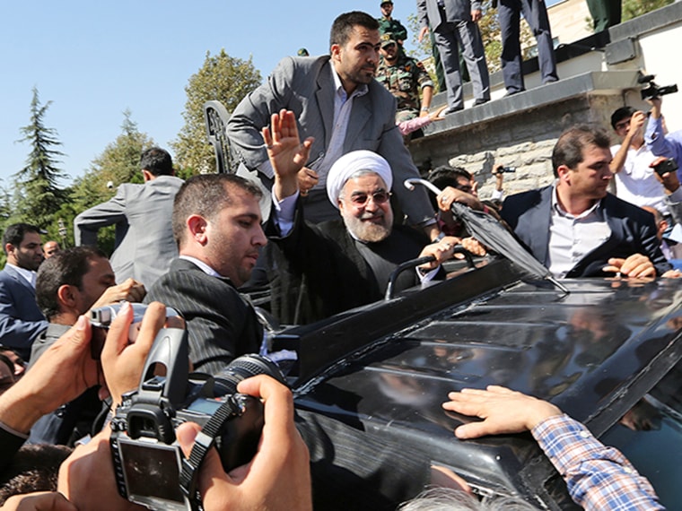 Iranian president Hassan Rouhani waves to supporters as his motorcade leaves Tehran's Mehrabad Airport after his arrival from New York on Sept. 28.