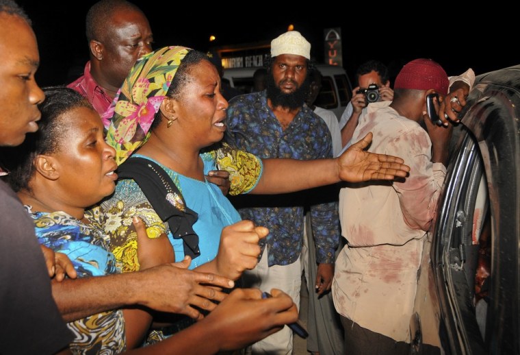 Relatives and friends gather around the vehicle in which Sheikh Ibrahim Ismael and three others were killed near Mombasa, Kenya.