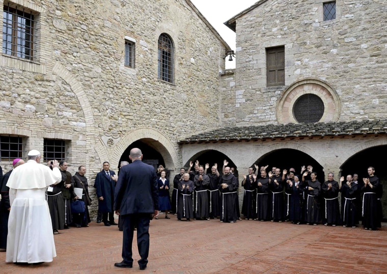 Pope Francis waves to monks at the San Damian monastery in Assisi.