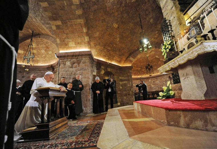 Pope Francis prays at the tomb of St. Francis in Assisi, Italy, on Friday.