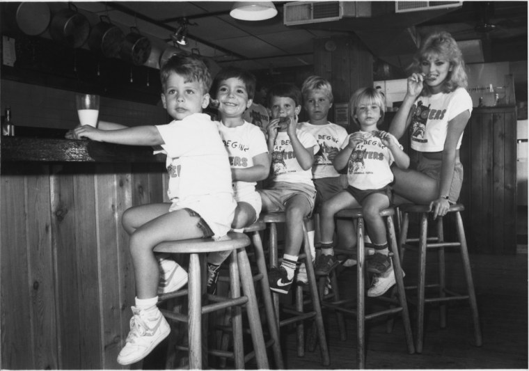 Original Hooters Girl Lynne Austin with some kiddos at the original Hooters of Clearwater, Fla.