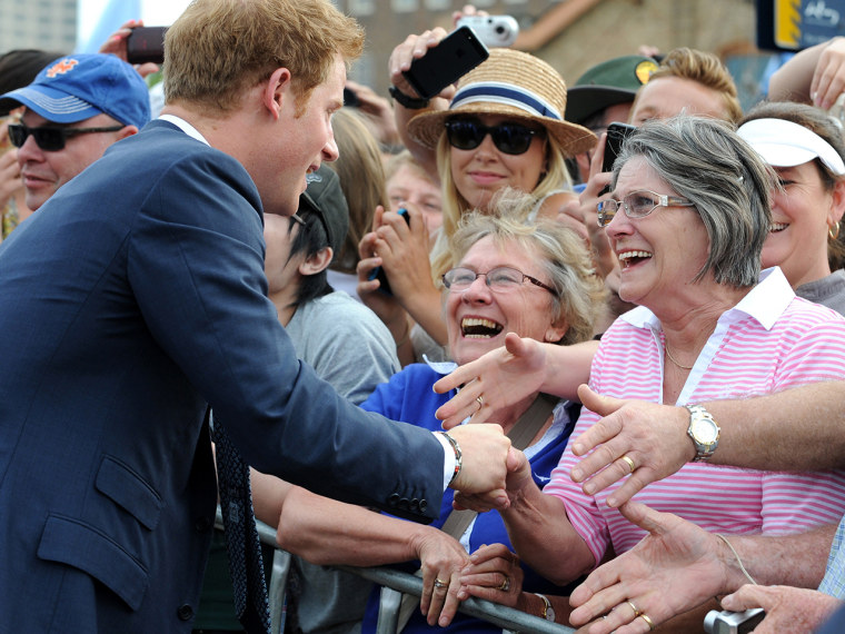 Britain's Prince Harry (L) meets members of the public during a walk around at Campbell's Cove in Sydney on October 5, 2013. Prince Harry is in Sydney...