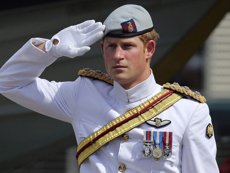 Britain's Prince Harry receives a royal salute from the honor guard at Garden Island Naval base in Sydney, Australia, Saturday, Oct. 5, 2013 before bo...