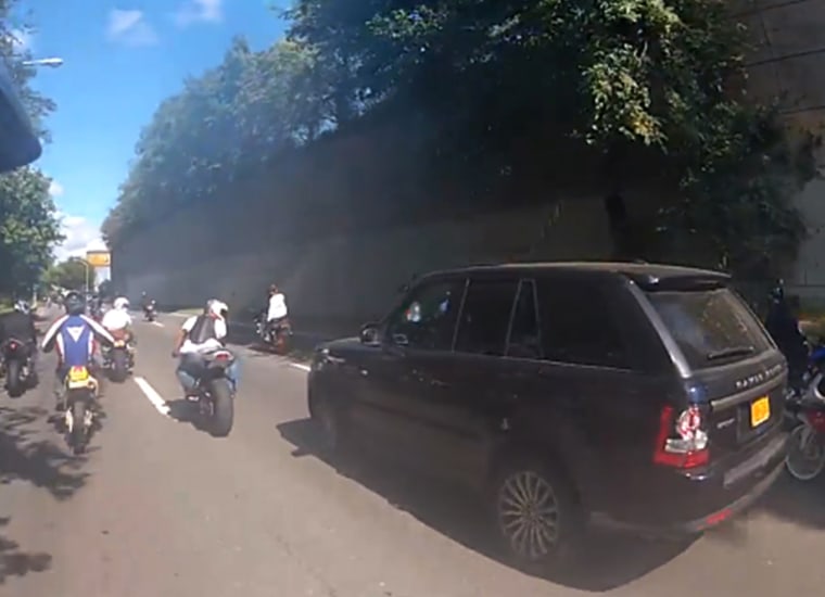 Motorcylces surround Alexian Lien's Range Rover on Manhattan's West Side Highway