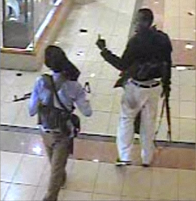 Two suspected militants with guns are seen in Westgate mall, in this still photograph taken from video broadcast on Kenya's Citizen TV showing closed-circuit television footage from September 21, 2013. Kenya's military spokesman on October 5, 2013 named four men - including a Sudanese, a Kenyan Arab and a Somali - he said took part in the Islamist militant attack on Nairobi's Westgate shopping mall two weeks ago in which at least 67 people were killed. The CCTV footage from Westgate mall was broadcast on Kenyan television channels, apparently showing at least four alleged attackers with guns walking around the mall's supermarket and a storage room.