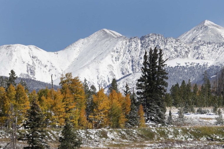 Fresh snow covers the mountain peaks east of Frisco, Colo., Saturday Oct. 5, 2013. A rare winter storm swept across the central Rocky Mountains and traveled across the Great Plains on Oct. 4, in an unusual blend of winter and autumn.
