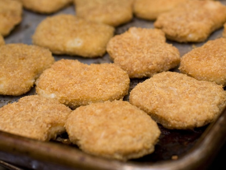 Chicken nuggets, fresh from the oven, are seen in this May 2, 2010 photo. Kids love chicken nuggets, but Consumer Reports says watch out for fat and s...